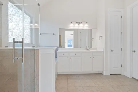 a spacious bathroom with double vanity mirror and a bathtub