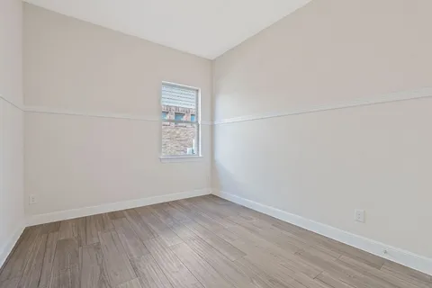 a view of a room that has wooden floor in it