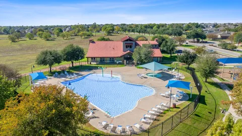 an aerial view of a house with yard swimming pool and outdoor seating