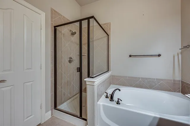 a bathroom with a bathtub and a shower