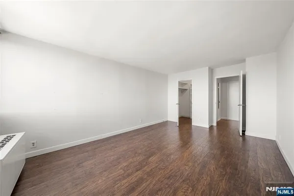 a view of walk in closet with empty racks