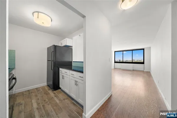a kitchen with stainless steel appliances and wooden cabinets