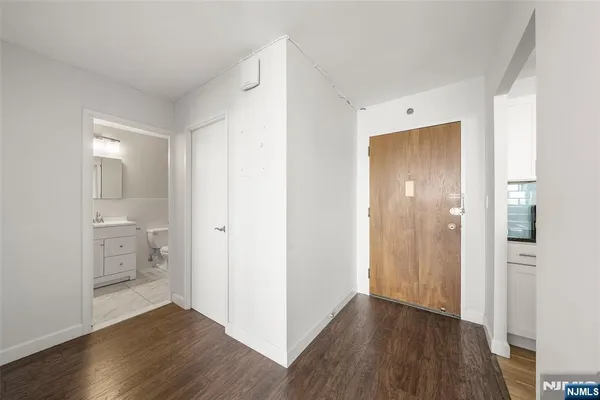 a view of a hallway with wooden floor