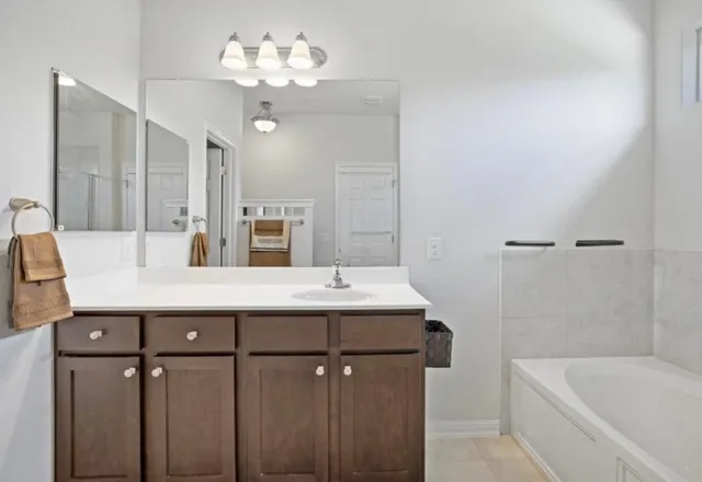 a bathroom with a bathtub shower sink and toilet