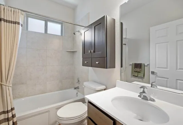 a view of hallway with a large window and wooden floor