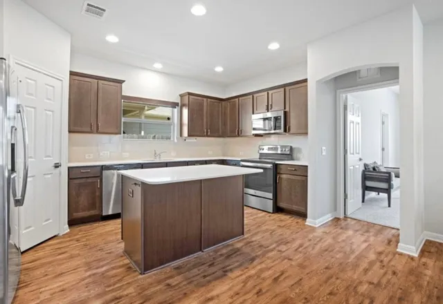 a kitchen with stainless steel appliances wooden cabinets and granite counter tops