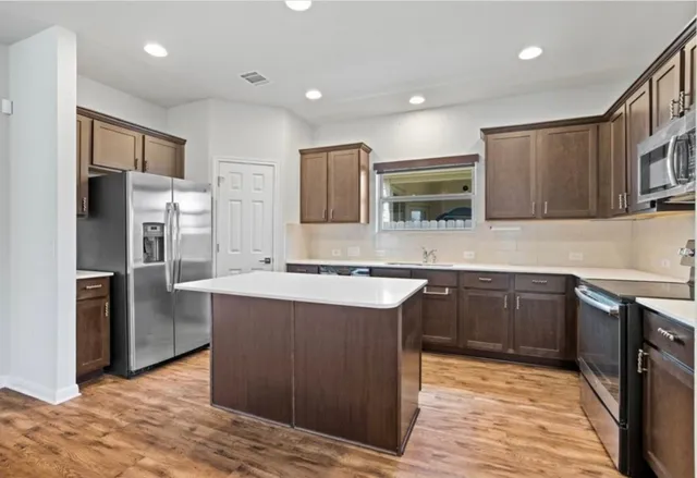 a kitchen with a stove a sink and a refrigerator