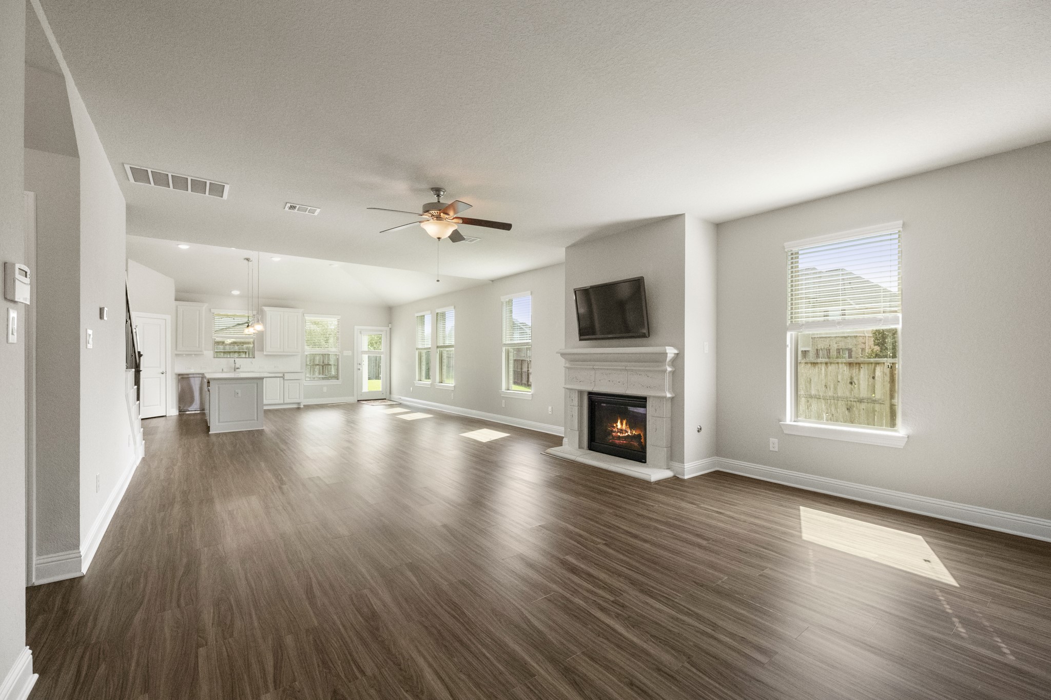 7502 Windsor Park Court Spring, TX 77379 - Photo 8 of 50 a view of a living room and kitchen with furniture wooden floor and a fireplace