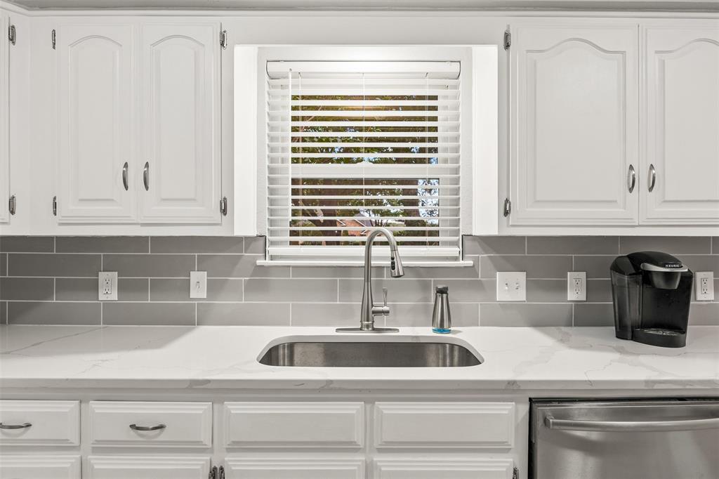 909 Valley View Avenue Red Oak, TX 75154 - Photo 12 of 37 a kitchen with white cabinets and a sink