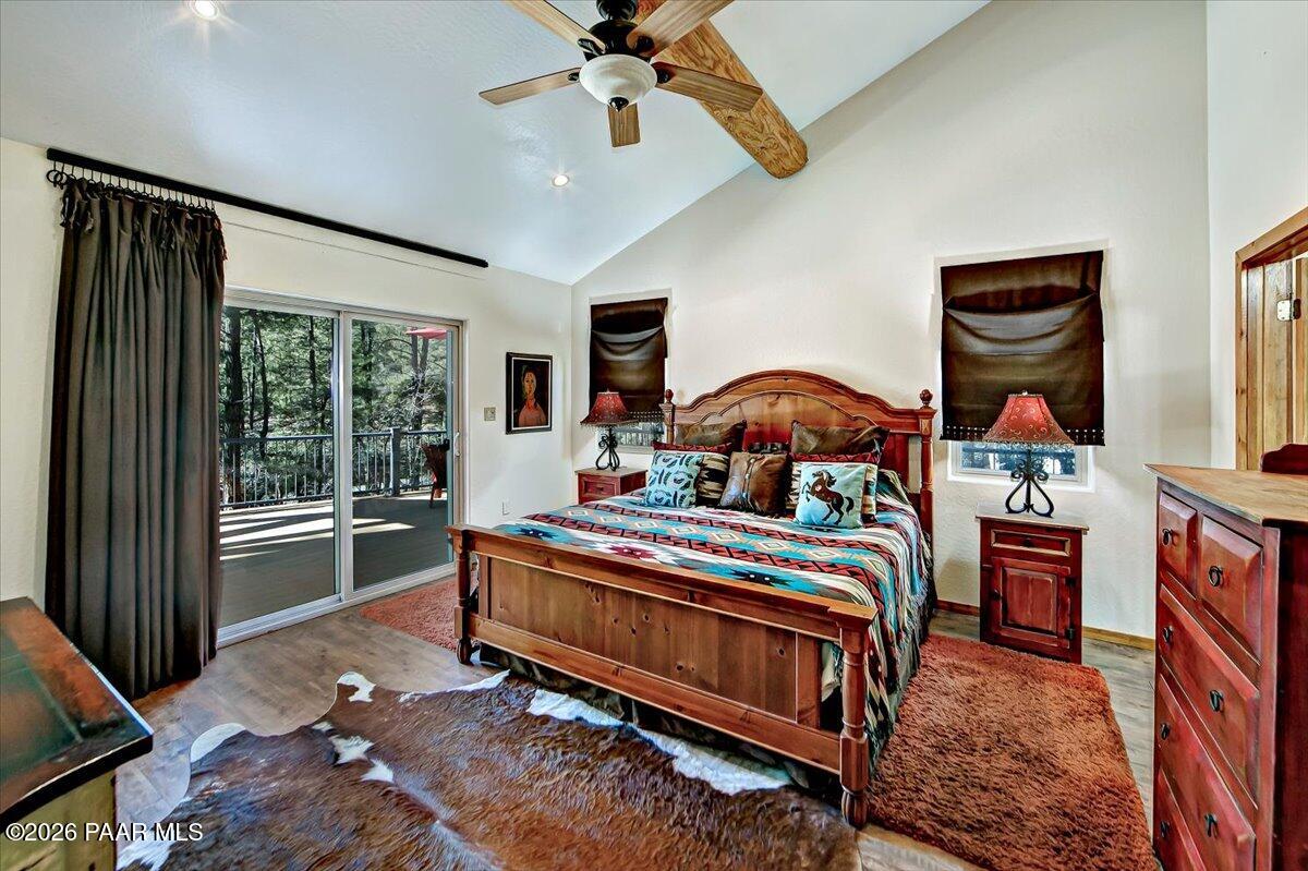 835 Happy Valley Road Prescott, AZ 86305 - Photo 16 of 48 a bedroom with a bed and a chandelier