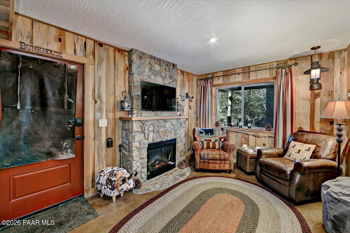 835 Happy Valley Road Prescott, AZ 86305 - Photo 24 of 48 a living room with furniture a flat screen tv and a fireplace