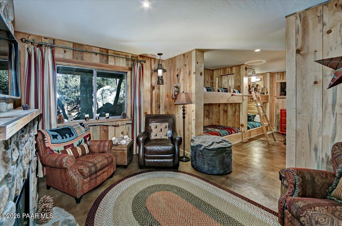 835 Happy Valley Road Prescott, AZ 86305 - Photo 25 of 48 a living room with furniture a flat screen tv and a floor to ceiling window