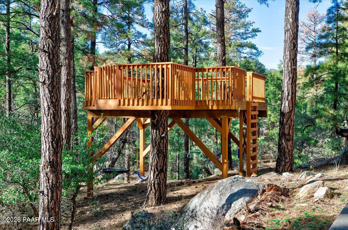 835 Happy Valley Road Prescott, AZ 86305 - Photo 38 of 48 a view of a wooden deck with large trees and wooden fence