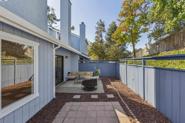 a view of a balcony with chairs and a potted plant
