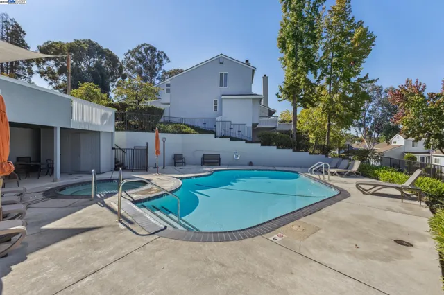 a view of a chairs and table in backyard