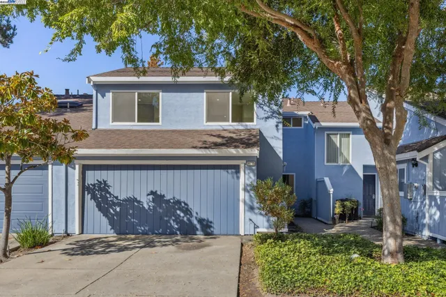 a view of a house with a yard and pathway