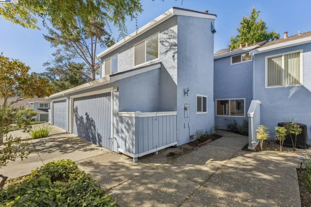 a view of a hallway with wooden floor and glass door