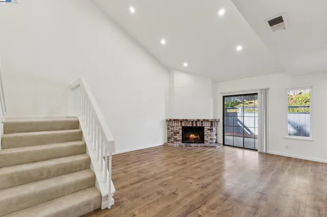 a spacious bathroom with a double vanity sink toilet and mirror