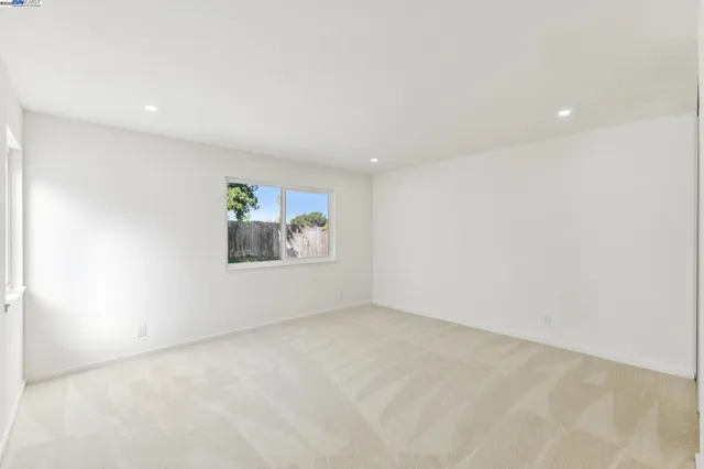 a bathroom with a granite countertop sink a mirror and a bathtub