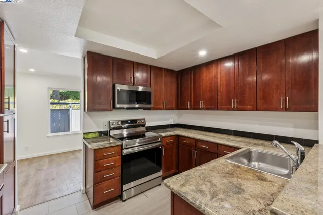 a kitchen that has a sink and a stove in it
