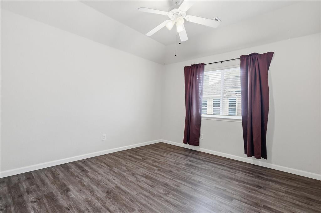 4545 Ridgepointe Drive The Colony, TX 75056 - Photo 33 of 37 Spacious room featuring vaulted ceilings, wood-finish flooring, a window with horizontal blinds, and a ceiling fan with integrated lighting