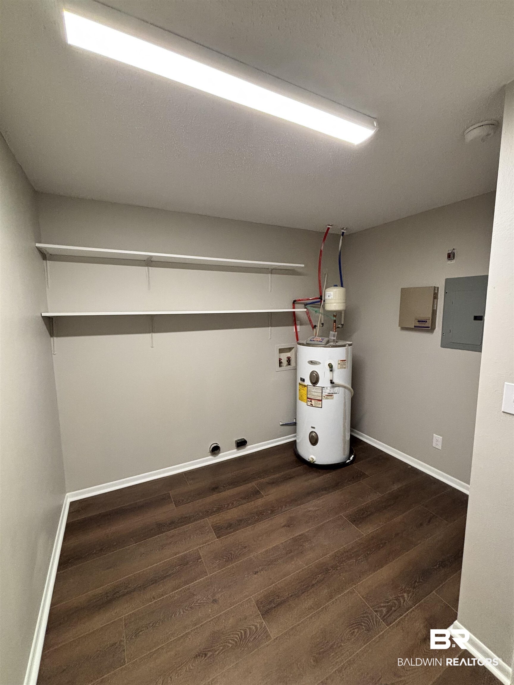 10 Soldiers Route Daphne, AL 36527 - Photo 14 of 26 Washroom featuring dark wood finished floors, electric panel, electric water heater, washer hookup, and a textured ceiling
