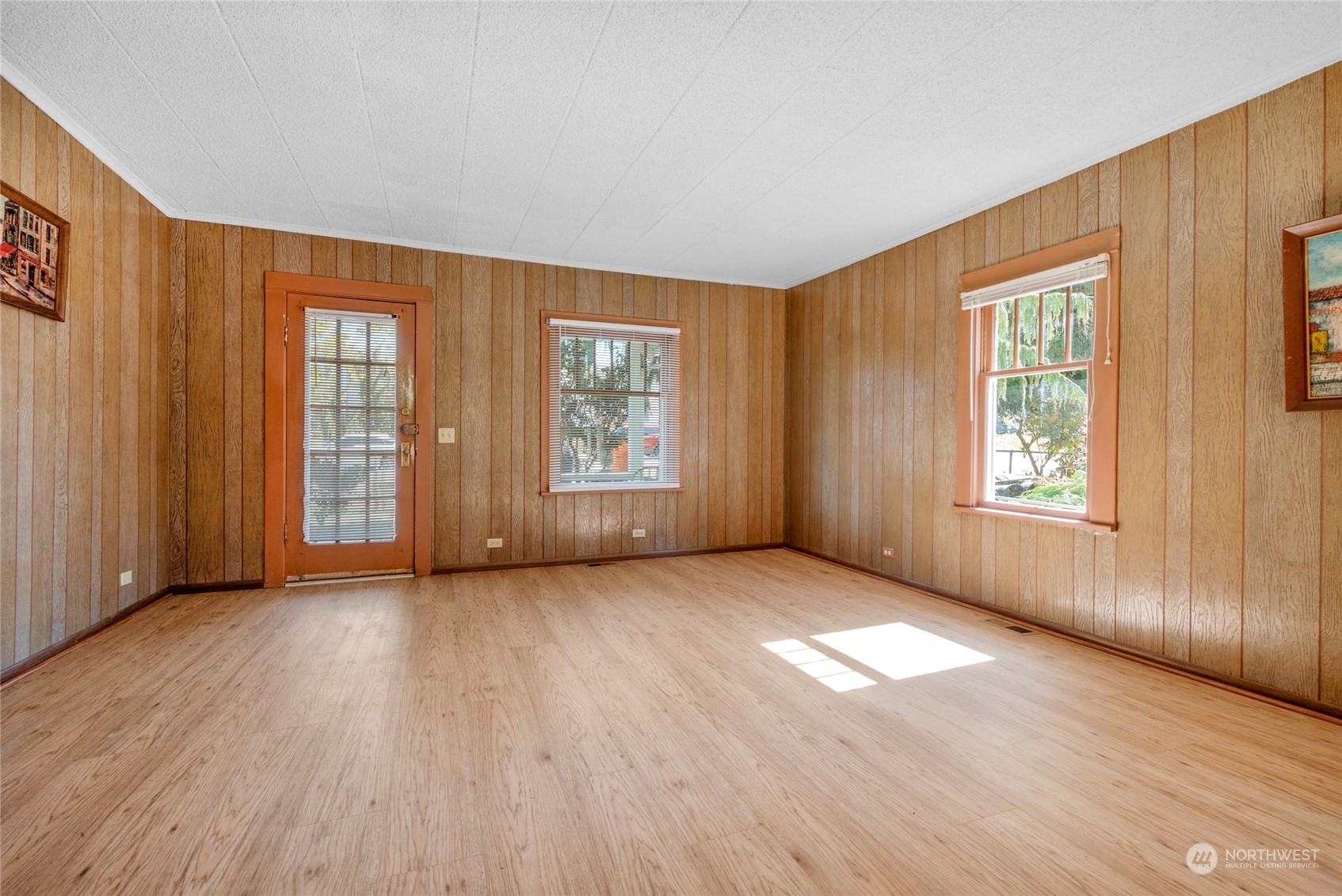 5416 Rockefeller Avenue Everett, WA 98203 - Photo 8 of 35 an empty room with wooden floor and windows with curtains view
