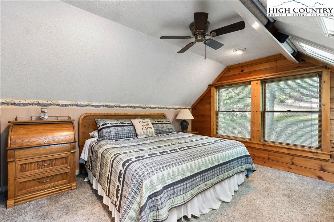 289 Grandview Drive Seven Devils, NC 28604 - Photo 24 of 43 a bedroom with a bed and a large window