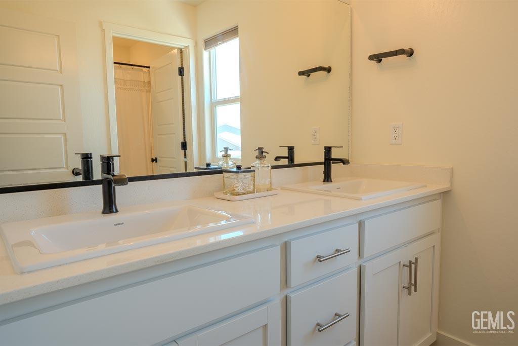 Undisclosed Address Bakersfield, CA 93311 - Photo 19 of 24 a bathroom with a sink and a mirror