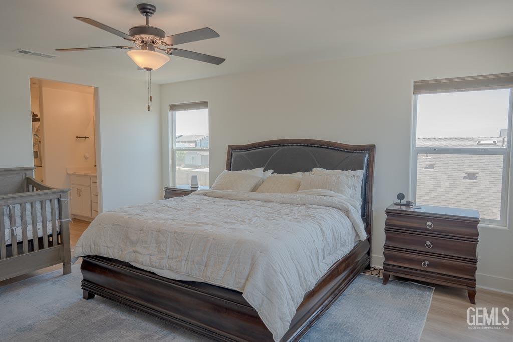 Undisclosed Address Bakersfield, CA 93311 - Photo 20 of 24 a bedroom with a bed and a chandelier