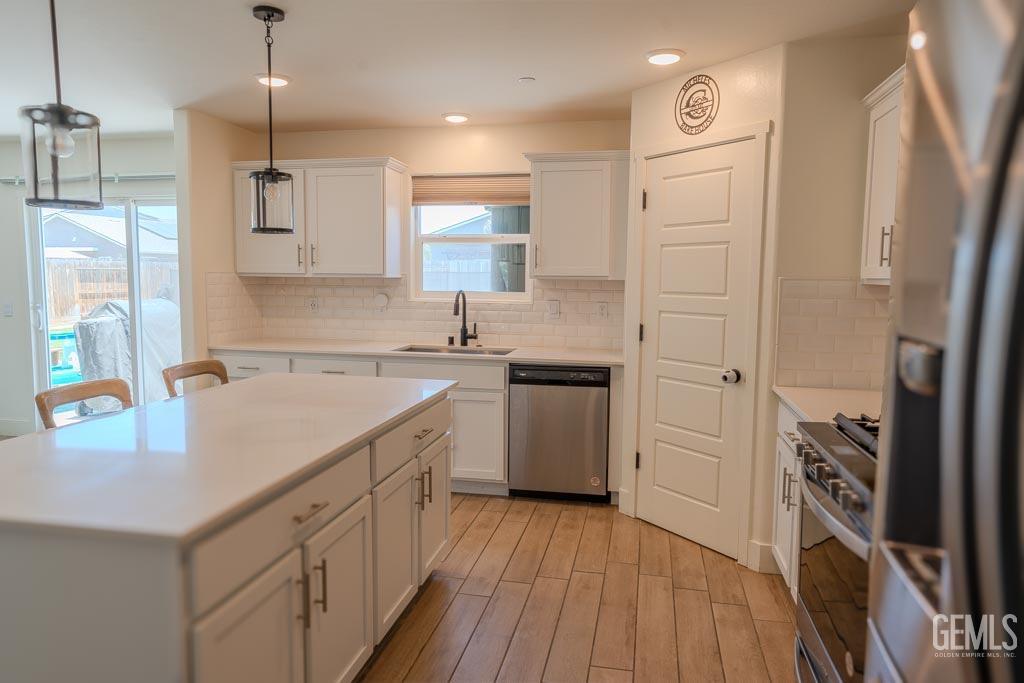 Undisclosed Address Bakersfield, CA 93311 - Photo 10 of 24 a kitchen with a sink a stove a refrigerator and a window