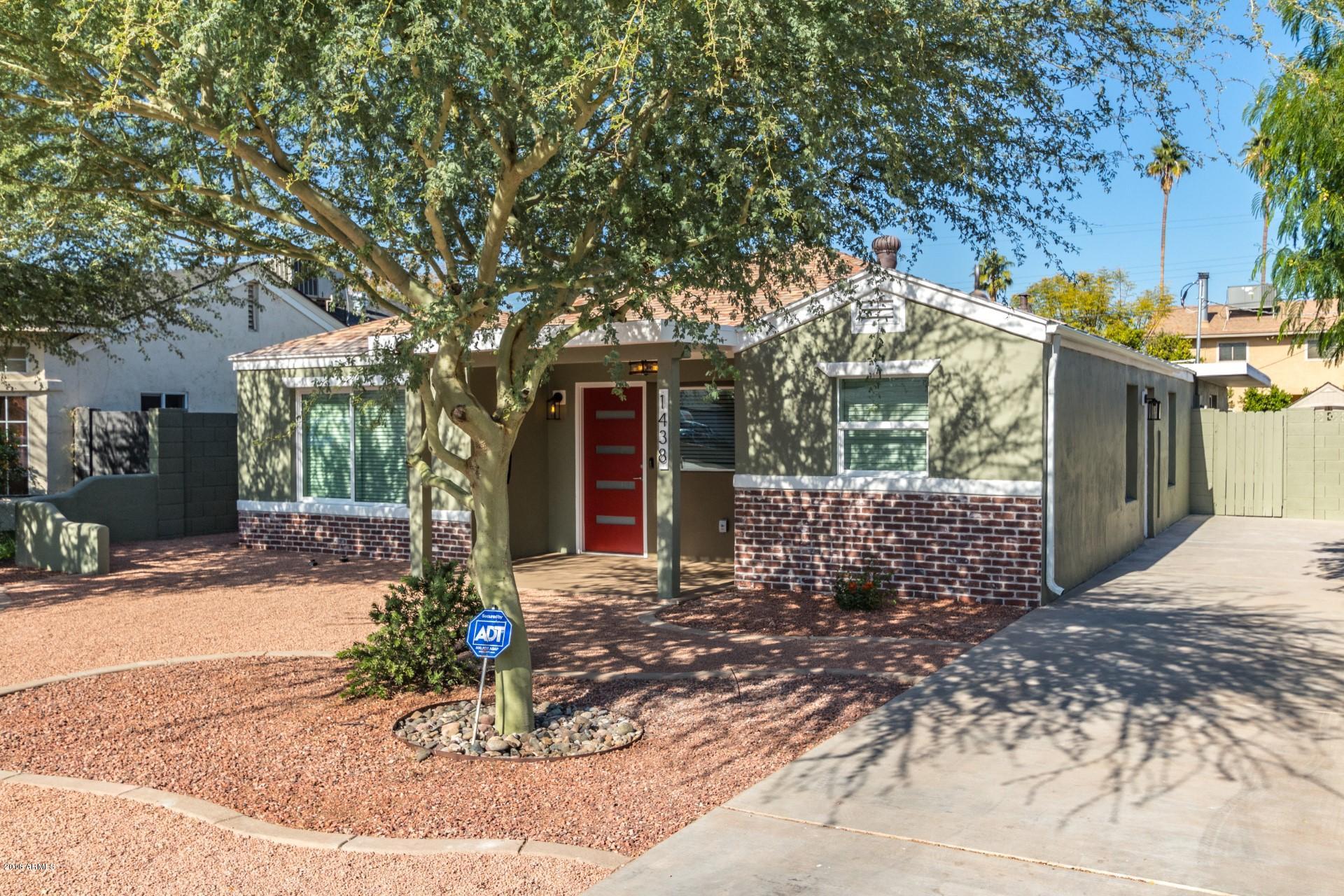 1438 East Granada Road Phoenix, AZ 85006 - Photo 2 of 35 a front view of a house with a yard and potted plants