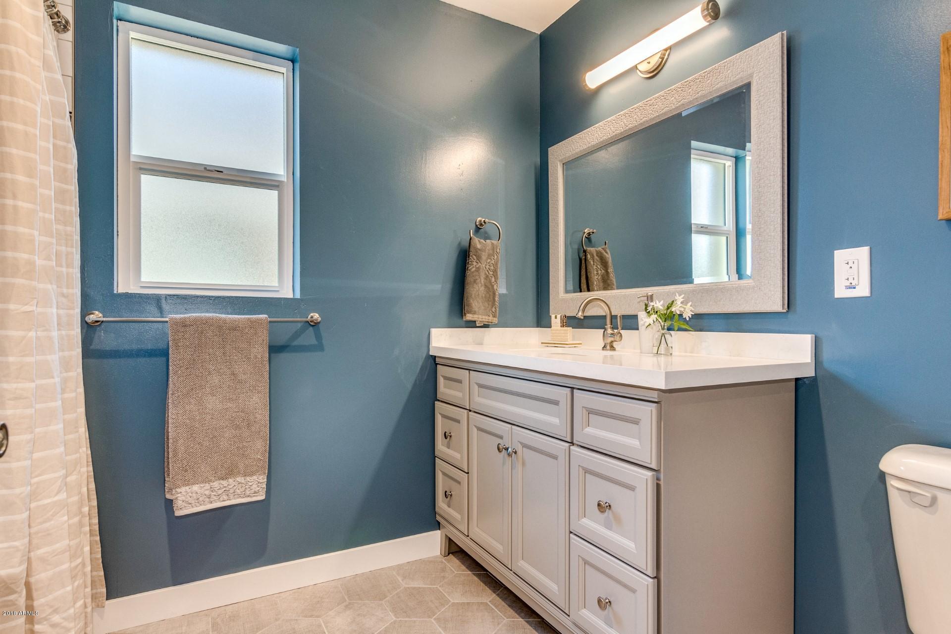 1438 East Granada Road Phoenix, AZ 85006 - Photo 23 of 35 a bathroom with a double vanity sink and a mirror