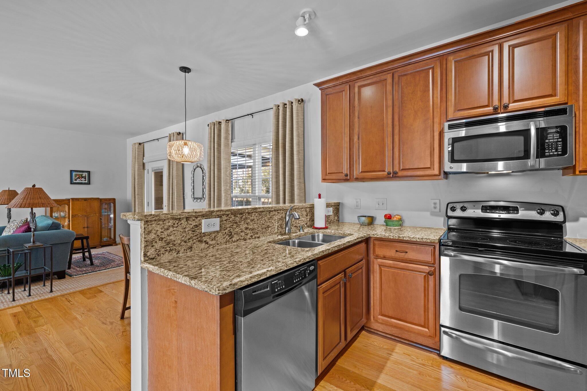 203 Stoney Drive Durham, NC 27703 - Photo 21 of 59 a kitchen with stainless steel appliances granite countertop a stove sink and microwave