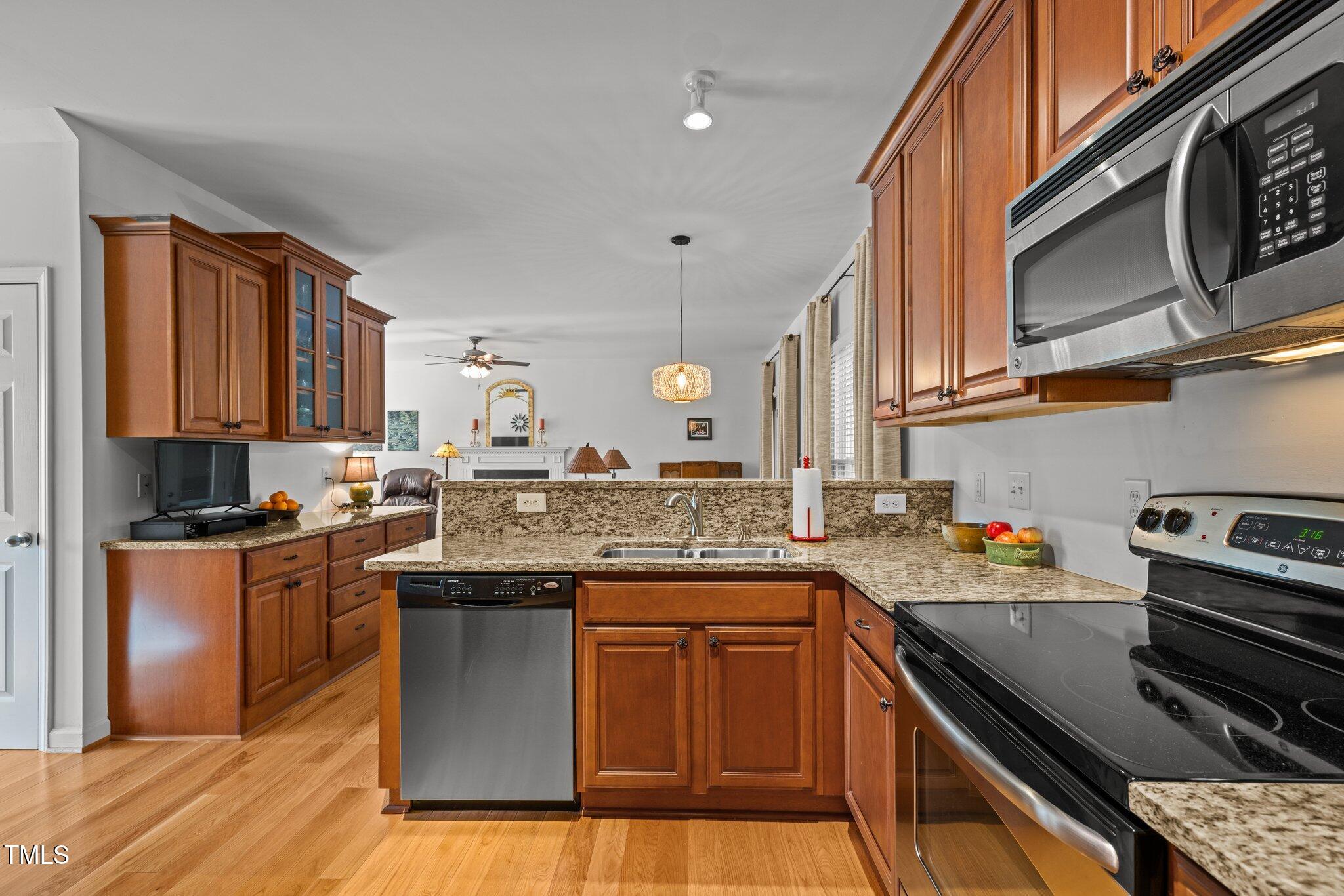 203 Stoney Drive Durham, NC 27703 - Photo 22 of 59 a kitchen with stainless steel appliances granite countertop a stove a sink dishwasher and microwave oven with cabinets