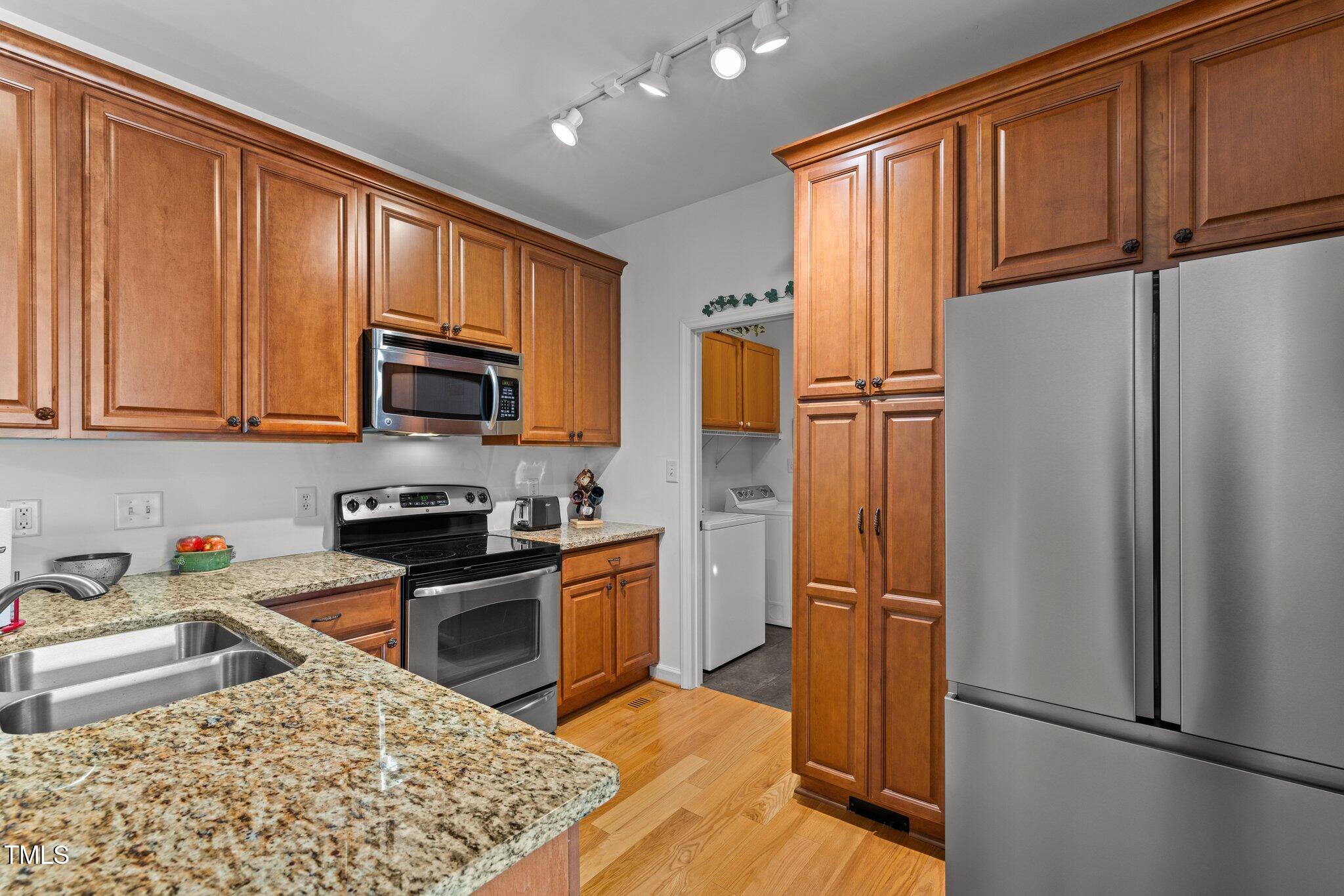 203 Stoney Drive Durham, NC 27703 - Photo 23 of 59 a kitchen with stainless steel appliances granite countertop a refrigerator stove top oven and sink