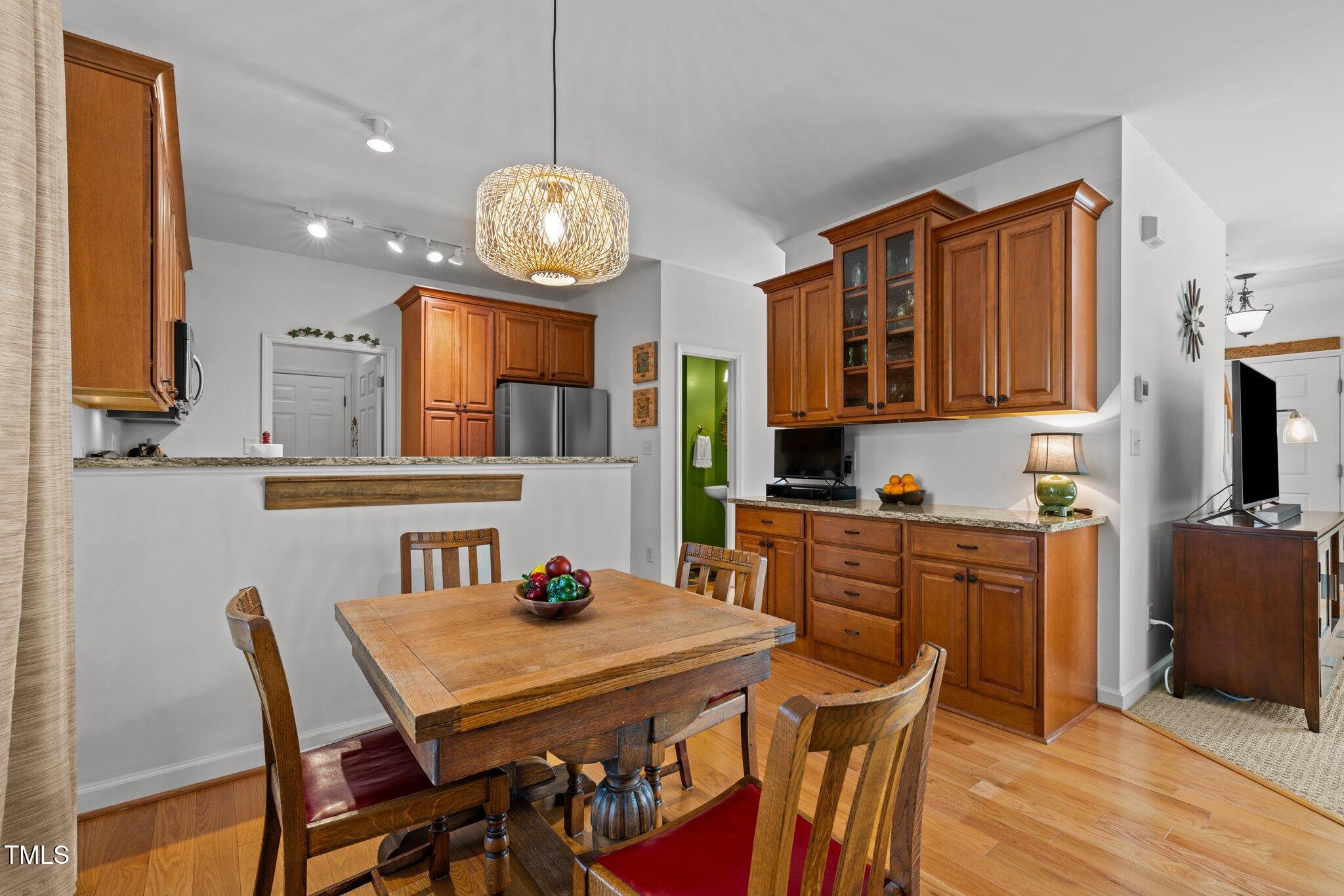 203 Stoney Drive Durham, NC 27703 - Photo 25 of 59 a kitchen with stainless steel appliances granite countertop a dining table chairs refrigerator and sink