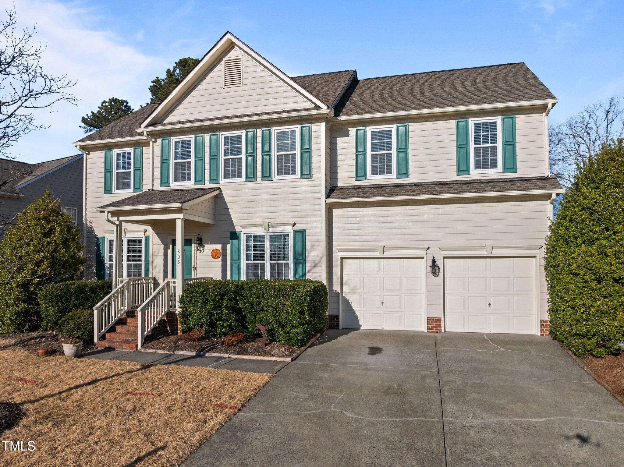 203 Stoney Drive Durham, NC 27703 - Photo 3 of 59 a front view of a house with a yard and garage