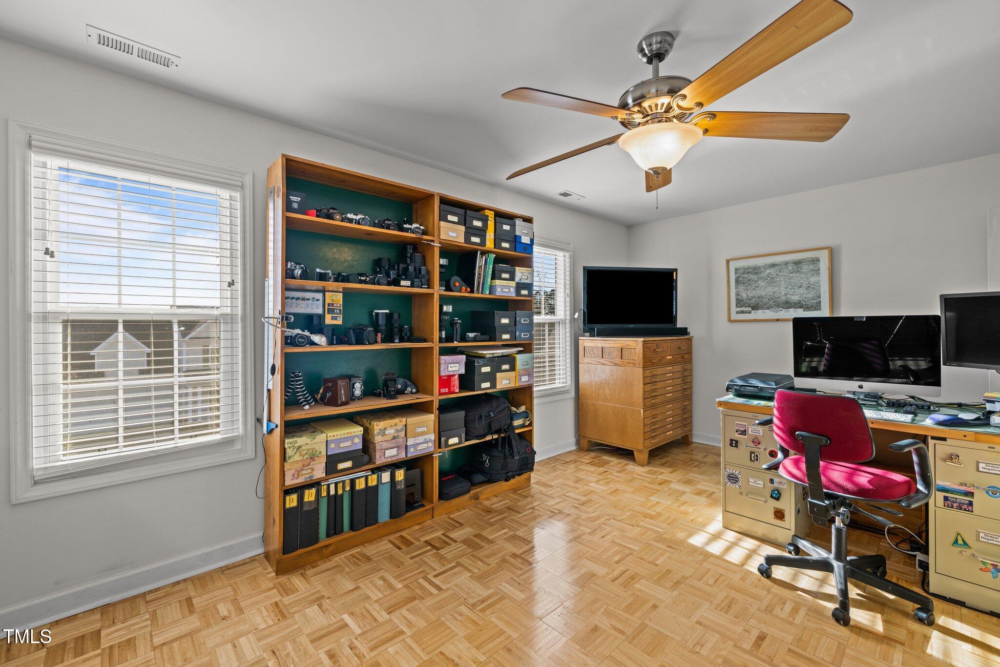 203 Stoney Drive Durham, NC 27703 - Photo 36 of 59 a workspace with a flat screen tv and a window