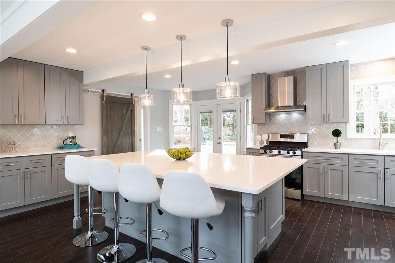 5501 Knollwood Road Raleigh, NC 27609 - Photo 1 of 25 a kitchen with stainless steel appliances granite countertop a sink a stove a refrigerator and island with wooden floor