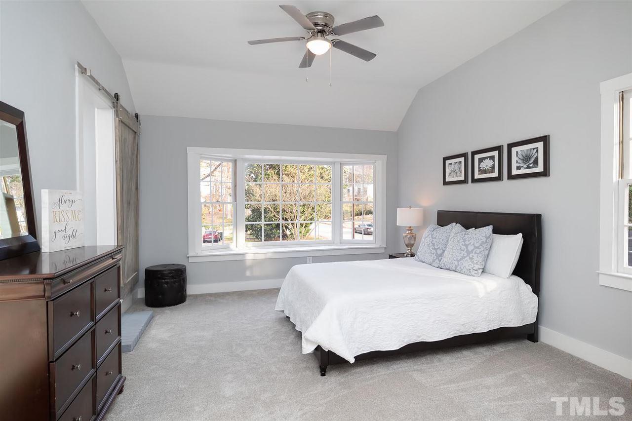 5501 Knollwood Road Raleigh, NC 27609 - Photo 12 of 25 a large bed sitting in a bedroom next to a window