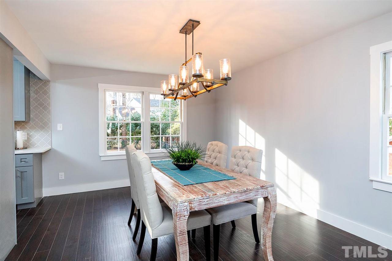 5501 Knollwood Road Raleigh, NC 27609 - Photo 16 of 25 a view of a dining room with furniture wooden floor and chandelier