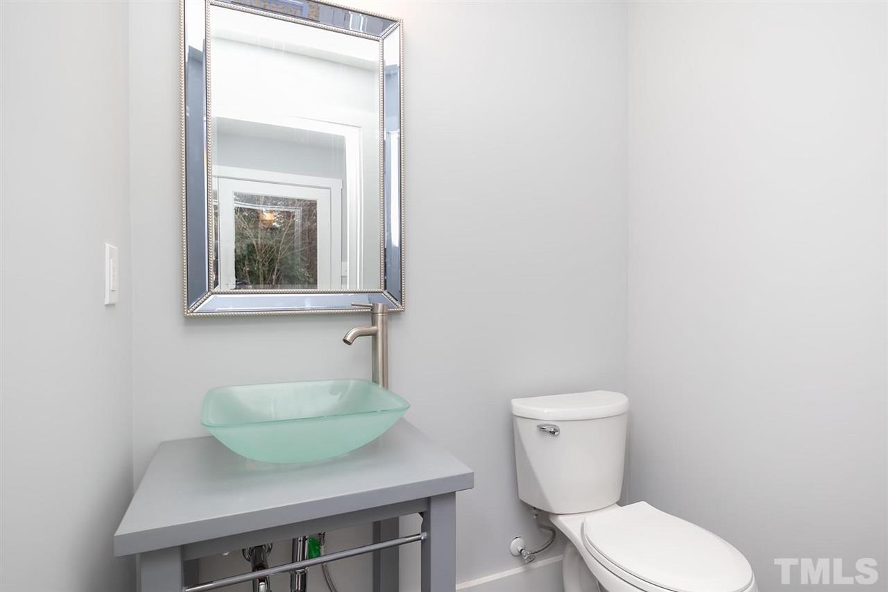 5501 Knollwood Road Raleigh, NC 27609 - Photo 17 of 25 a bathroom with a toilet a sink and mirror
