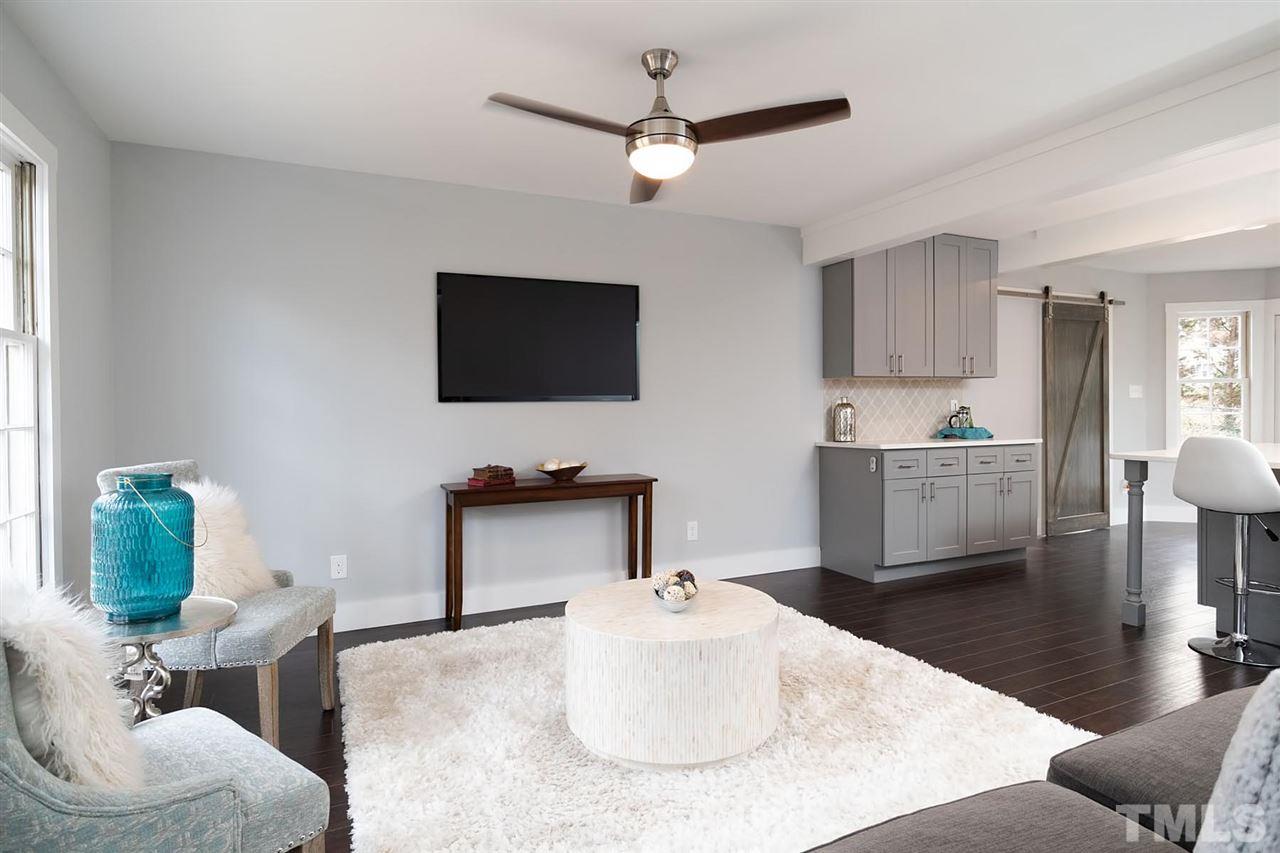 5501 Knollwood Road Raleigh, NC 27609 - Photo 3 of 25 a living room with furniture and a flat screen tv