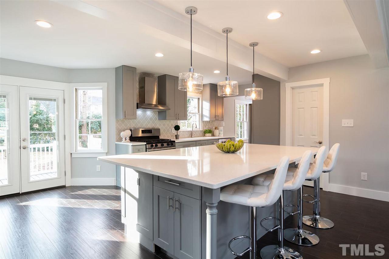 5501 Knollwood Road Raleigh, NC 27609 - Photo 7 of 25 a kitchen with a table chairs and white cabinets
