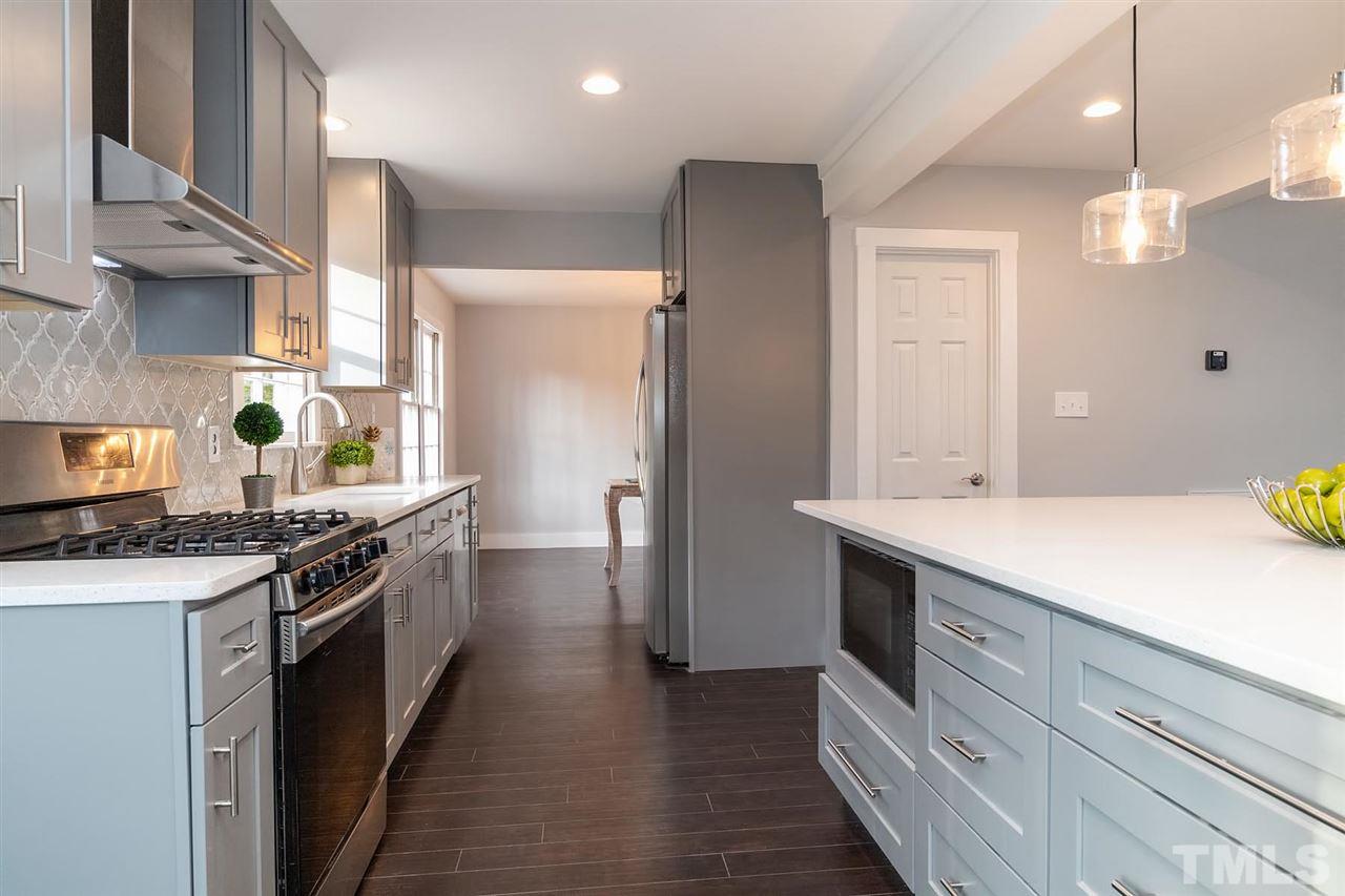 5501 Knollwood Road Raleigh, NC 27609 - Photo 8 of 25 a kitchen with a sink stove and refrigerator