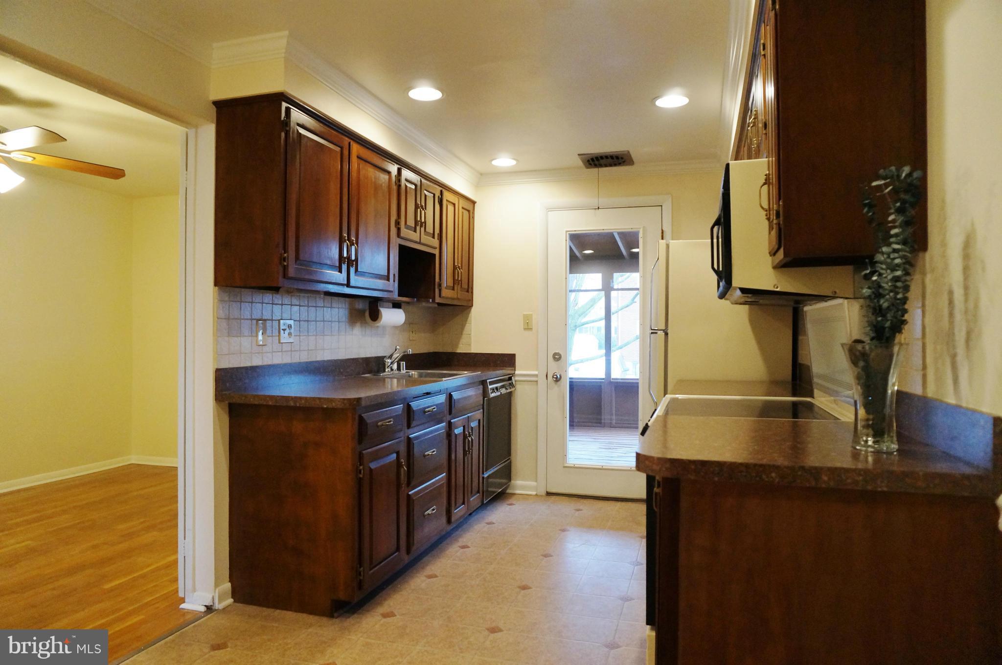 7811 Kavanagh Road Baltimore, MD 21222 - Photo 10 of 27 a kitchen with stainless steel appliances granite countertop a stove a sink and a microwave