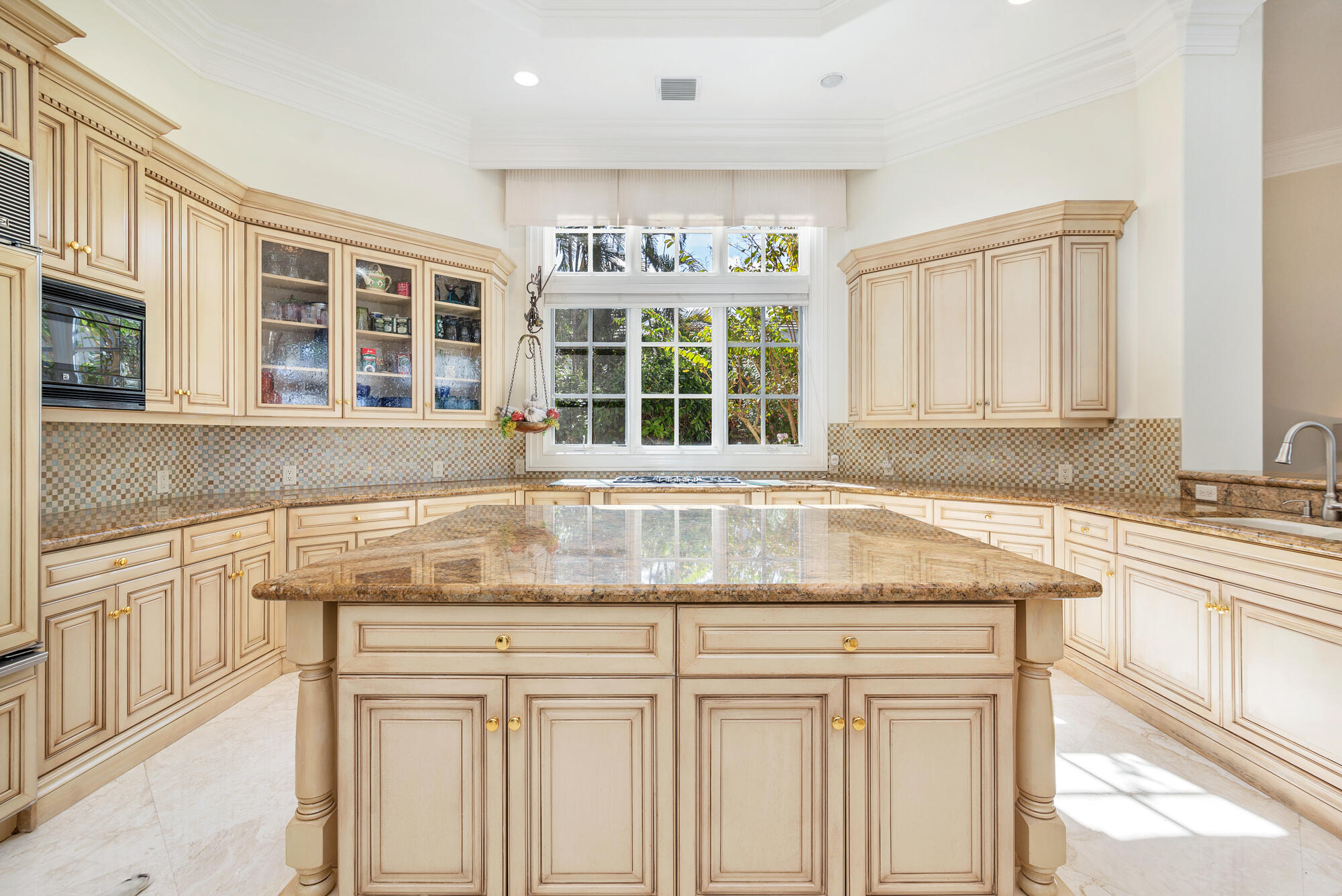19223 North Riverside Drive Tequesta, FL 33469 - Photo 18 of 83 a kitchen with granite countertop white cabinets and a window