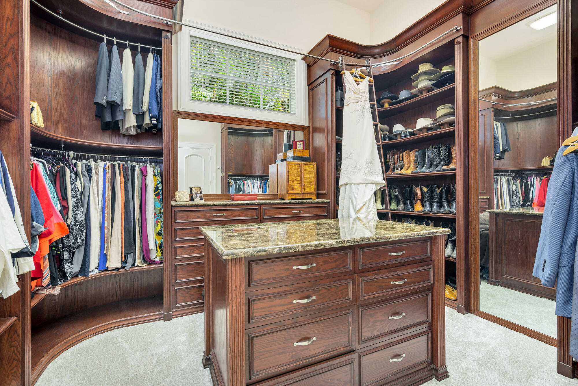 19223 North Riverside Drive Tequesta, FL 33469 - Photo 29 of 83 a view of walk in closet with clothes and shoes