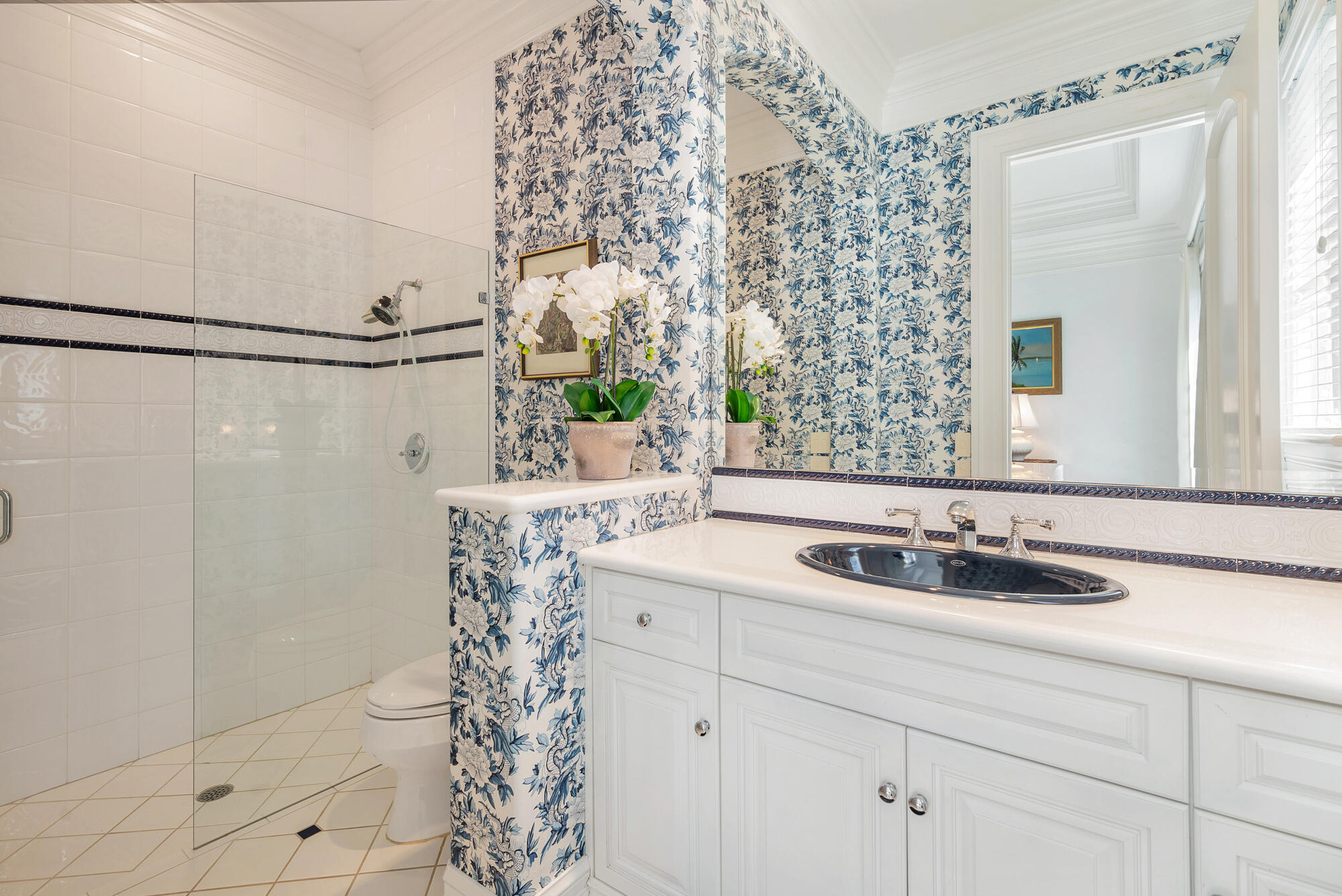 19223 North Riverside Drive Tequesta, FL 33469 - Photo 36 of 83 a bathroom with a sink a mirror and shower